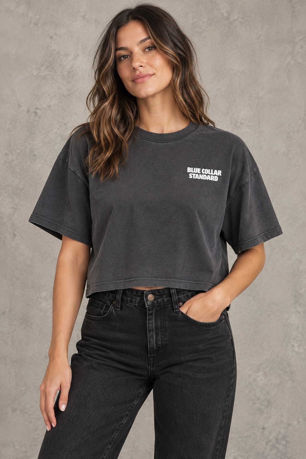 Woman wearing the charcoal Standard Heavyweight Crop Tee, front view with Blue Collar Standard chest logo